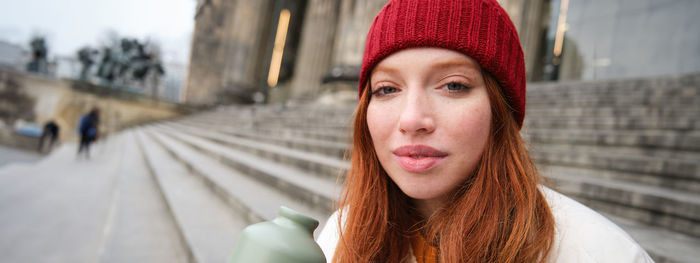 Portrait of young woman in city