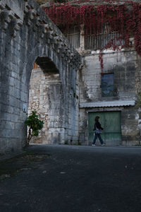 Full length of a man walking against building