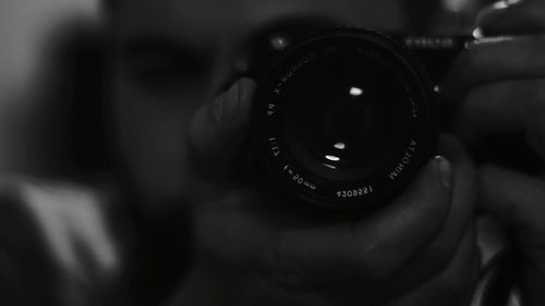 Close-up of woman photographing camera