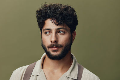 Portrait of young man against gray background