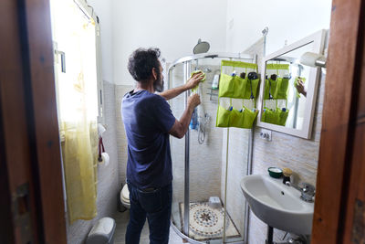Rear view of man working at home