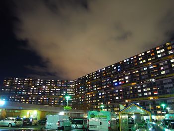 Illuminated cityscape against sky at night