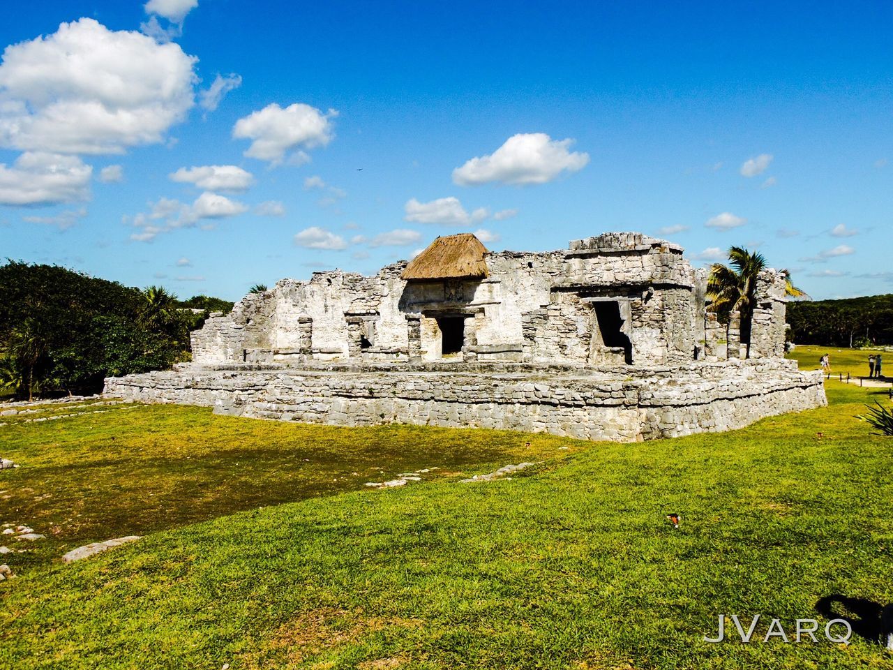 grass, architecture, sky, built structure, history, famous place, old ruin, ancient, travel destinations, building exterior, travel, tourism, the past, cloud - sky, ancient civilization, blue, archaeology, tree, cloud, green color