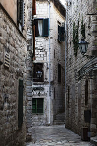 Alley amidst old buildings in city