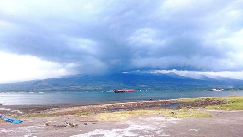 Scenic view of sea against cloudy sky