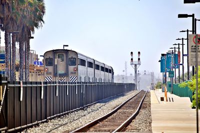 Train on railroad tracks against clear sky