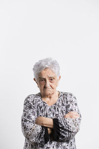 Portrait of mid adult man standing against white background