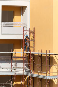 Man working at construction site against building