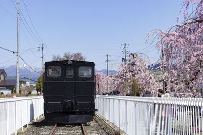 Train on railroad track against clear sky