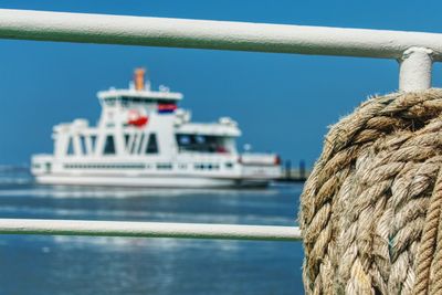 Close-up of ship by sea against clear sky