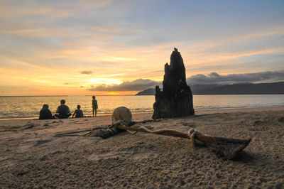 Rear view of people overlooking calm sea