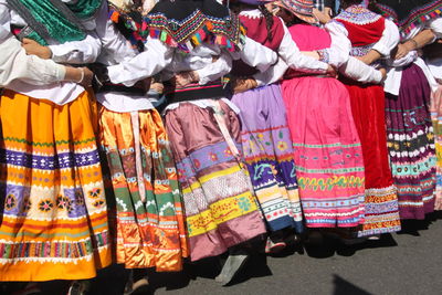 Women in traditional clothing dancing on road