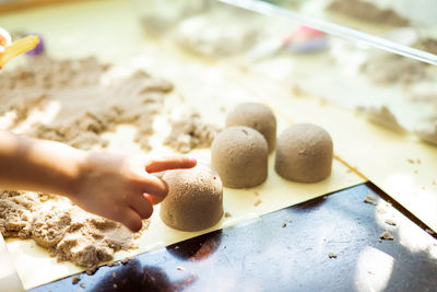 Close-up of boy holding sand