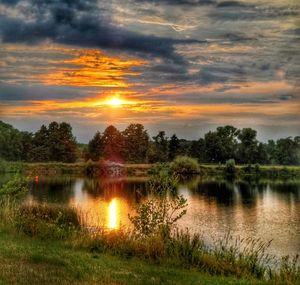 Scenic view of lake against sky during sunset