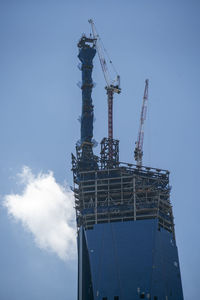 Low angle view of crane against sky