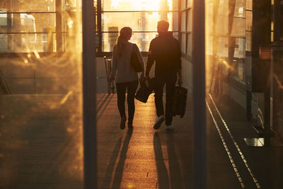 Silhouette of couple walking through corridor