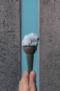 Blue colored ice cream cone with blue black back