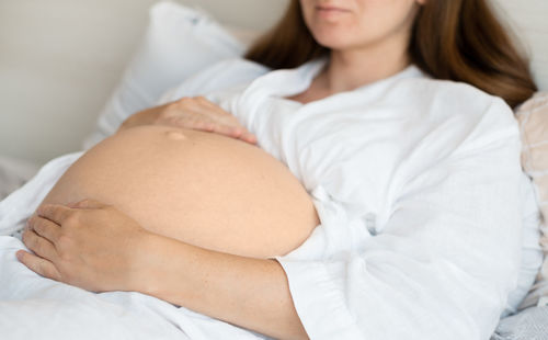 High angle view of woman lying on bed at home