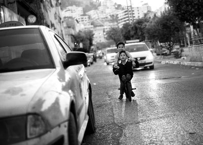 Man with umbrella walking on street in rainy season