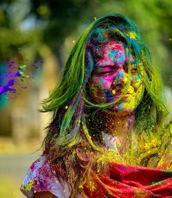 Young woman with powder paint on face during holi