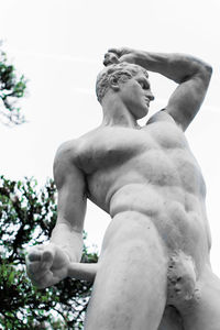 Low angle view of man statue against sky