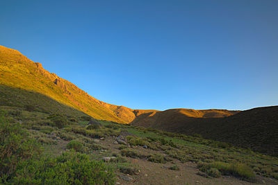 Scenic view of mountains against clear blue sky