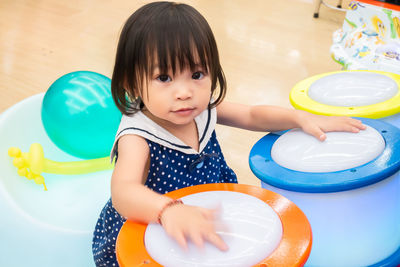 Portrait of baby girl playing music