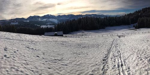 Scenic view of snow covered landscape against sky