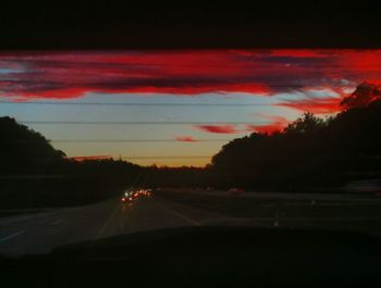 Cars on road against sky at night