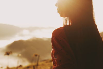 Close-up of woman with long hair against sky