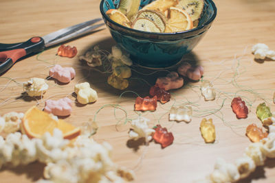 Close-up of gummy bears and strings on table during christmas