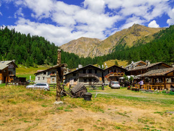 Houses on field against sky