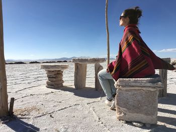 Woman sitting in desert