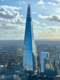 Modern buildings in city against sky