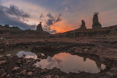 Scenic view of rock formation against sky during sunset