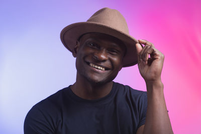 Low angle view of man wearing hat against clear sky