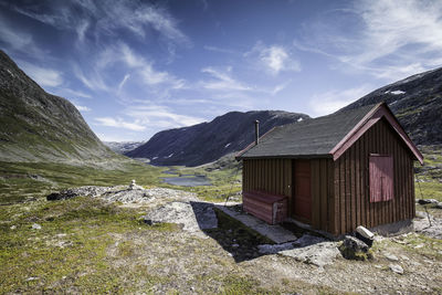 Scenic view of building and mountains against sky