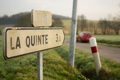 Close-up of information sign against sky