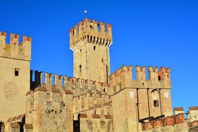 Low angle view of historic building against blue sky