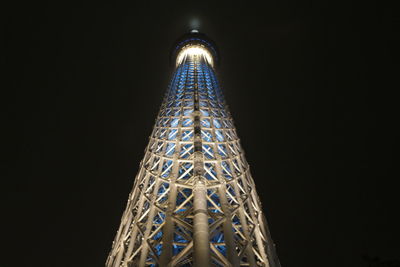 Low angle view of illuminated tower at night