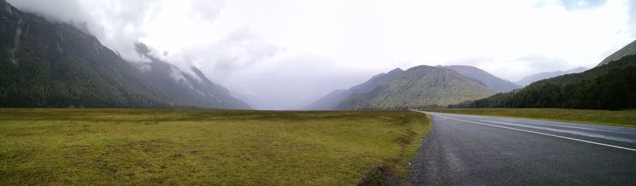 Empty road along countryside landscape