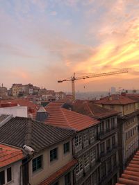 Buildings in city against sky during sunset