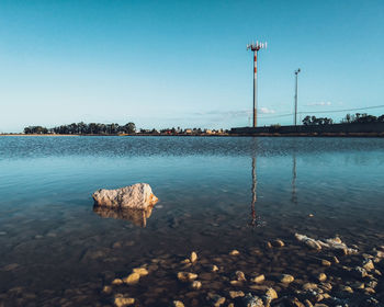 Scenic view of lake against clear blue sky