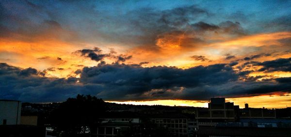 Cloudy sky above city at sunset