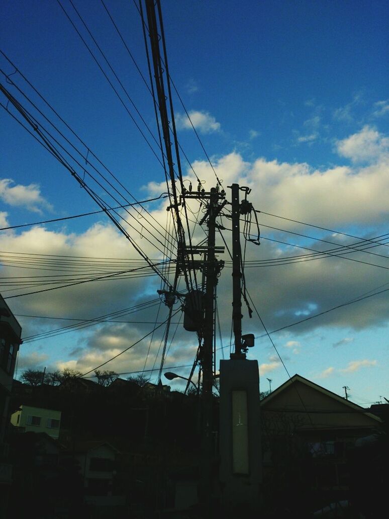 power line, electricity pylon, electricity, power supply, cable, sky, low angle view, connection, fuel and power generation, built structure, technology, architecture, building exterior, blue, cloud - sky, silhouette, power cable, cloud, dusk, outdoors