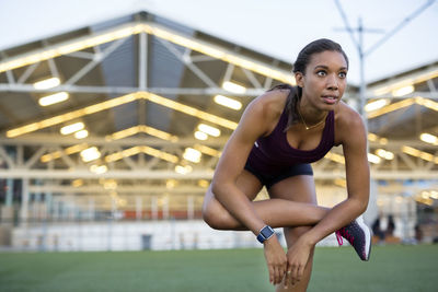 Athlete exercising on field during sunset