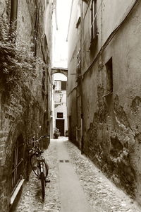 Alley amidst houses in city