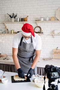 Rear view of man working in kitchen
