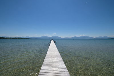 Scenic view of sea against clear blue sky