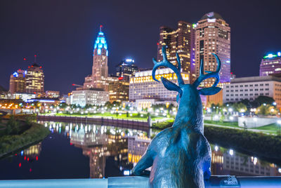 Statue of illuminated city at night